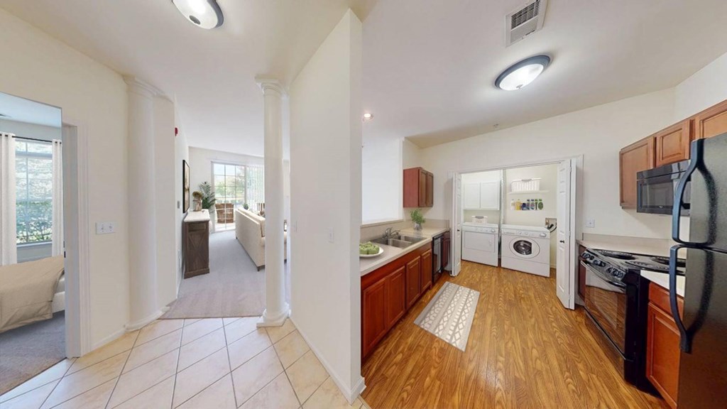 A kitchen with wooden floors and white appliances.