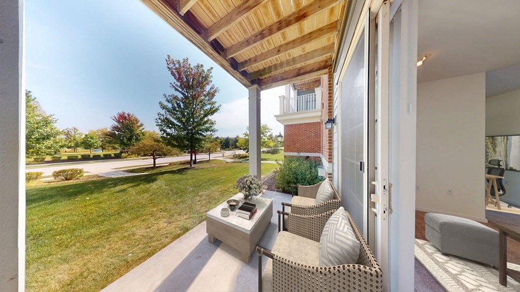 A patio with a couch and a table is shown.