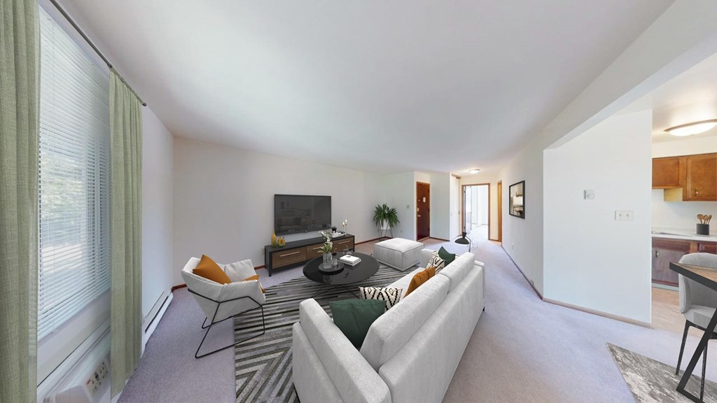 A living room with a white couch and a television.