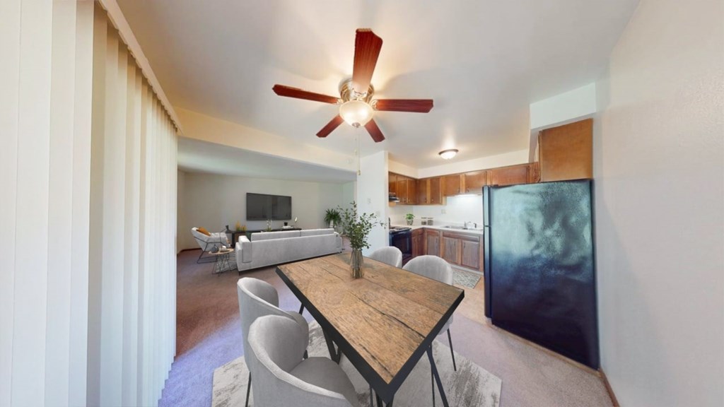 A dining room with a wooden table and chairs.