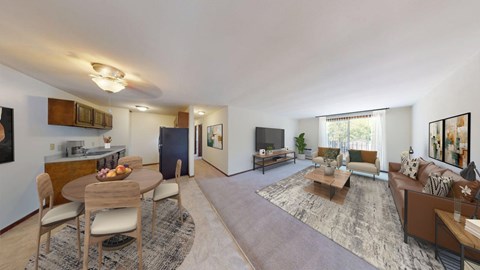 A spacious living room with a dining table and chairs.