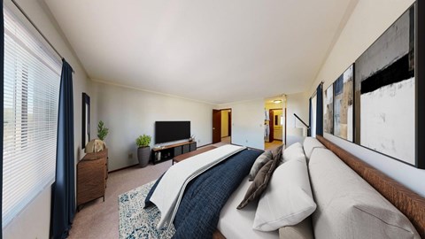 A bedroom with a large bed and a television.