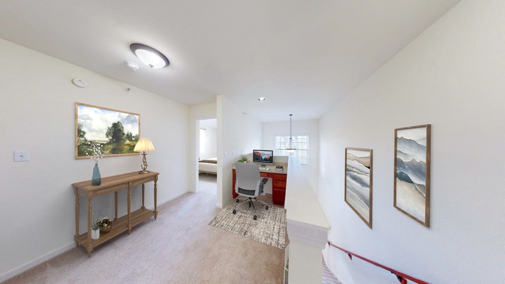 A room with a table, chairs, and pictures on the wall.