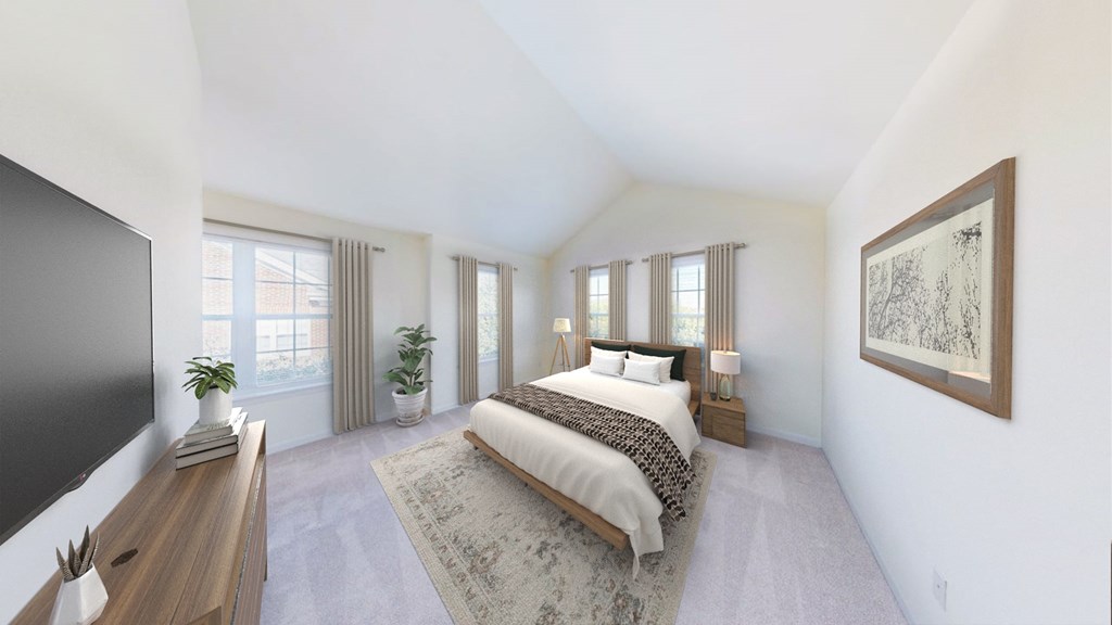 A bedroom with a large bed and a flat screen TV.