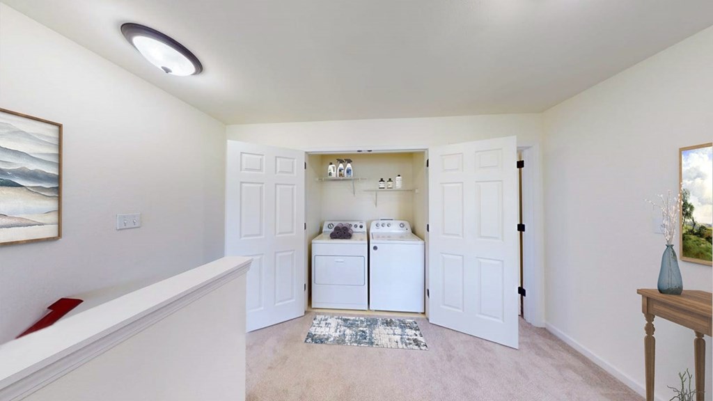 A white laundry room with a washer and dryer.
