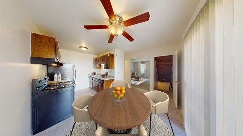 A modern kitchen with a wooden table and chairs.