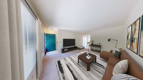 A living room with a brown couch and a television.