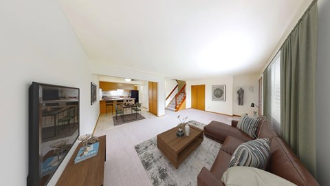 A living room with a brown couch and a flat screen TV.