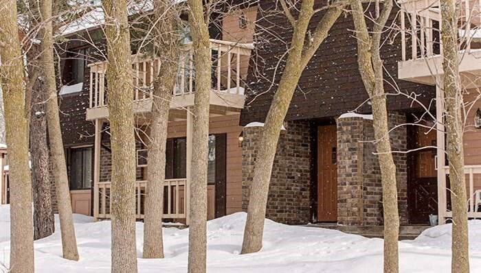 a house in the snow with trees