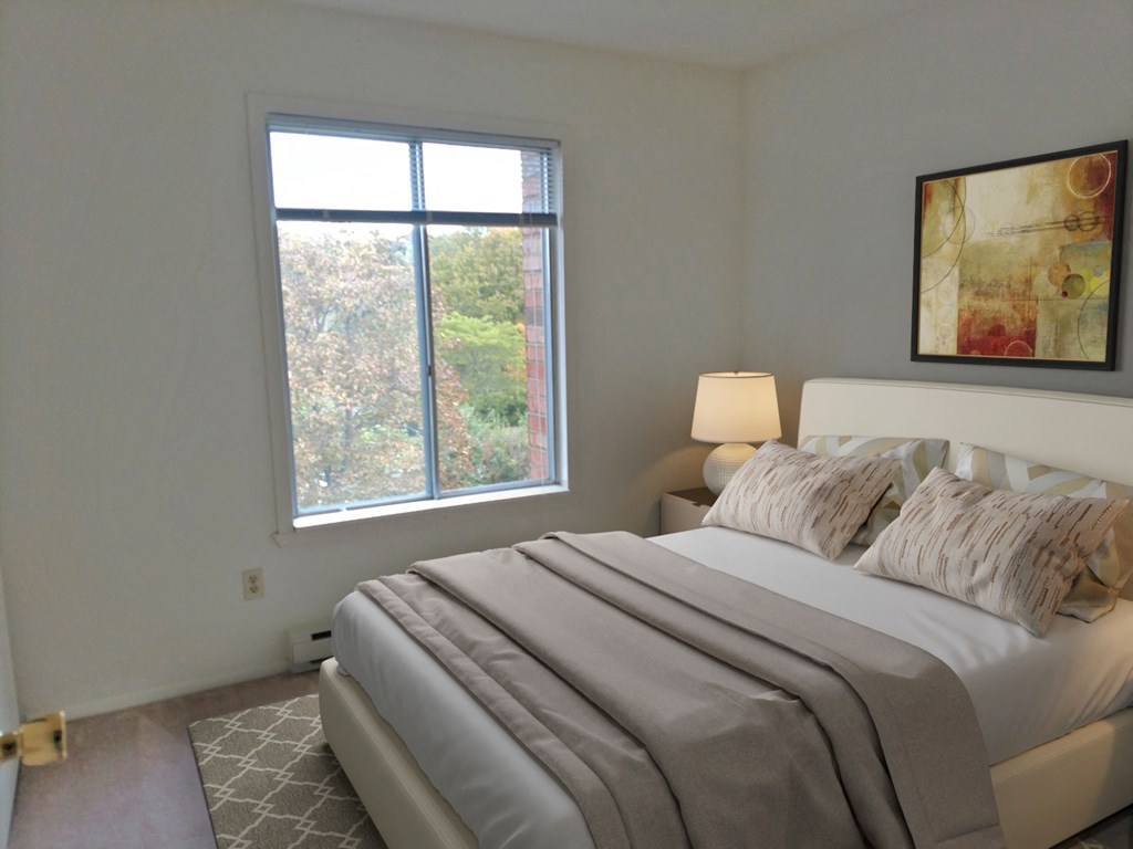 a bedroom with a large bed and a window