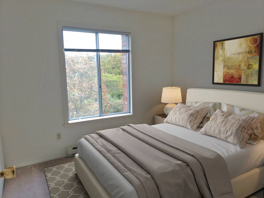 a bedroom with a large bed and a window