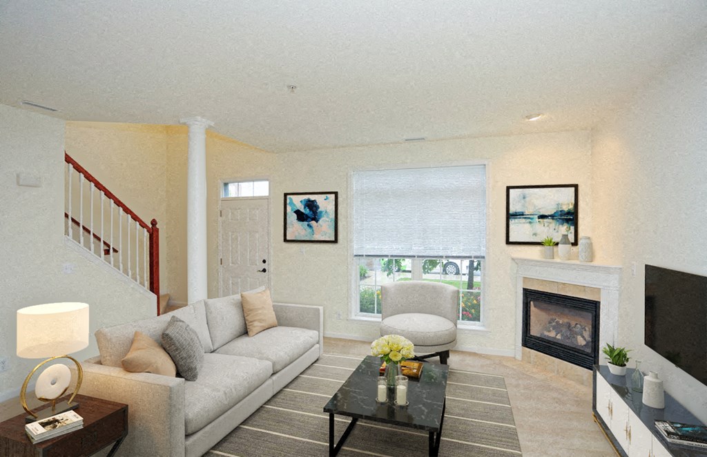 a living room with a couch and a chair and a fireplace