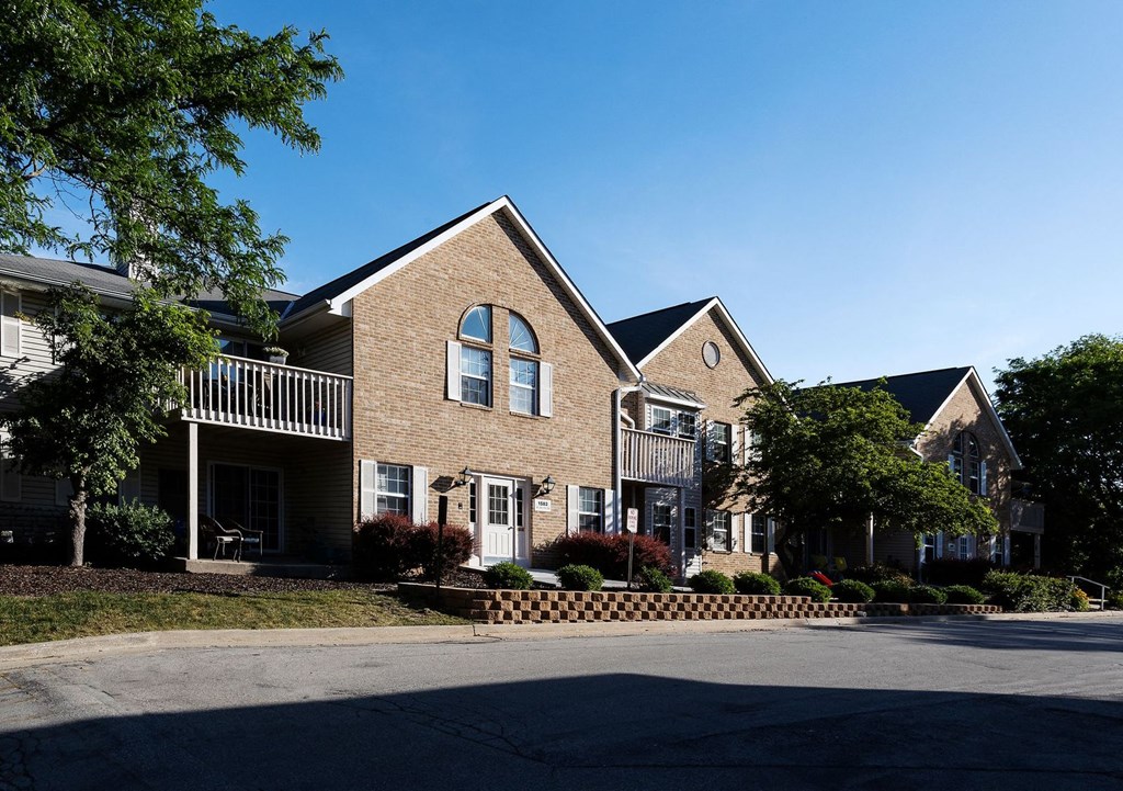 a brick house with a street in front of it