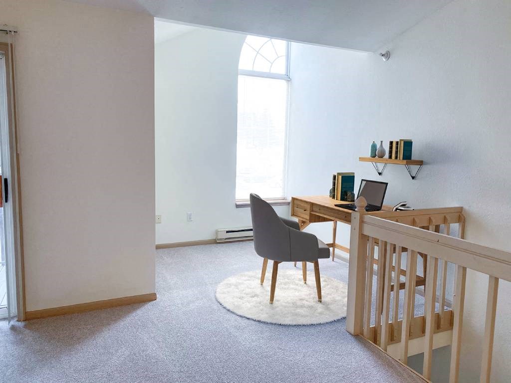 a nursery with a crib and a desk with a computer