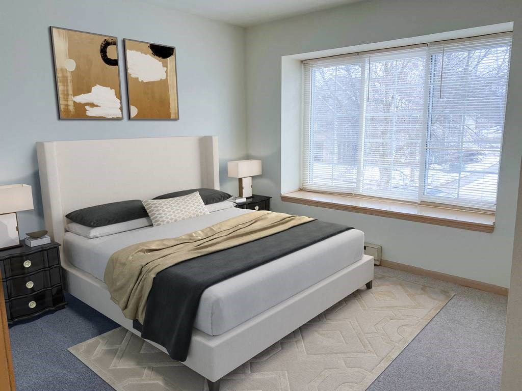 a bedroom with a bed and two windows