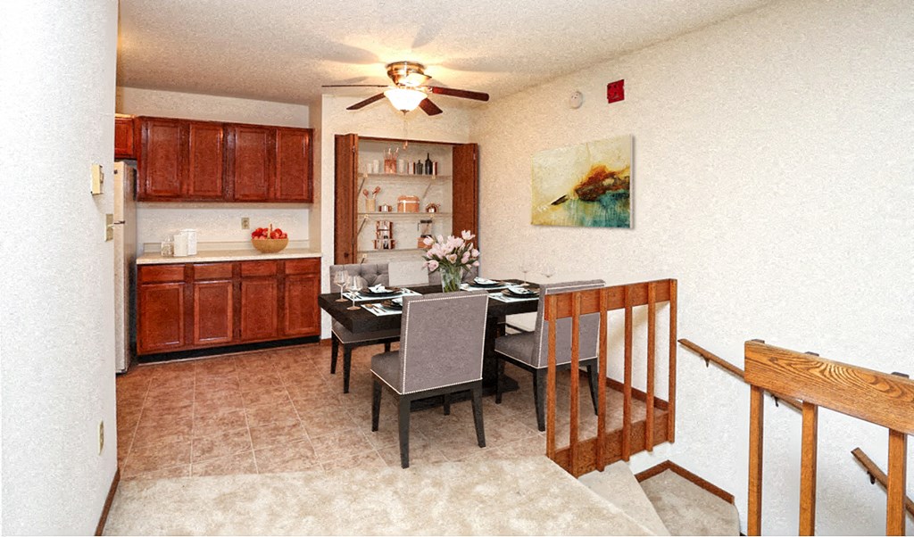 a dining room and kitchen with a table and chairs