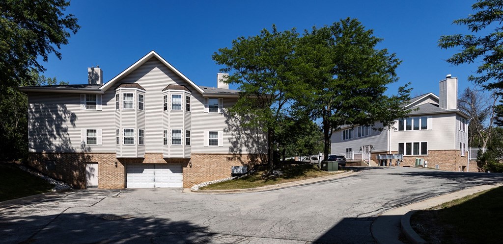 a large white house with a street in front of it