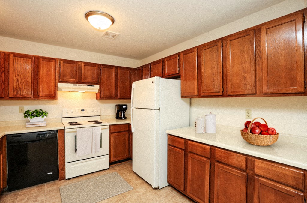 a kitchen with white appliances and wooden cabinets