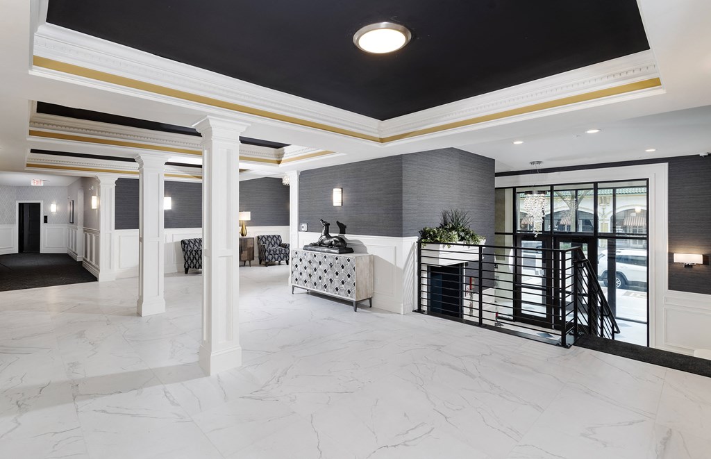 a large marble lobby with a reception desk and a balcony
