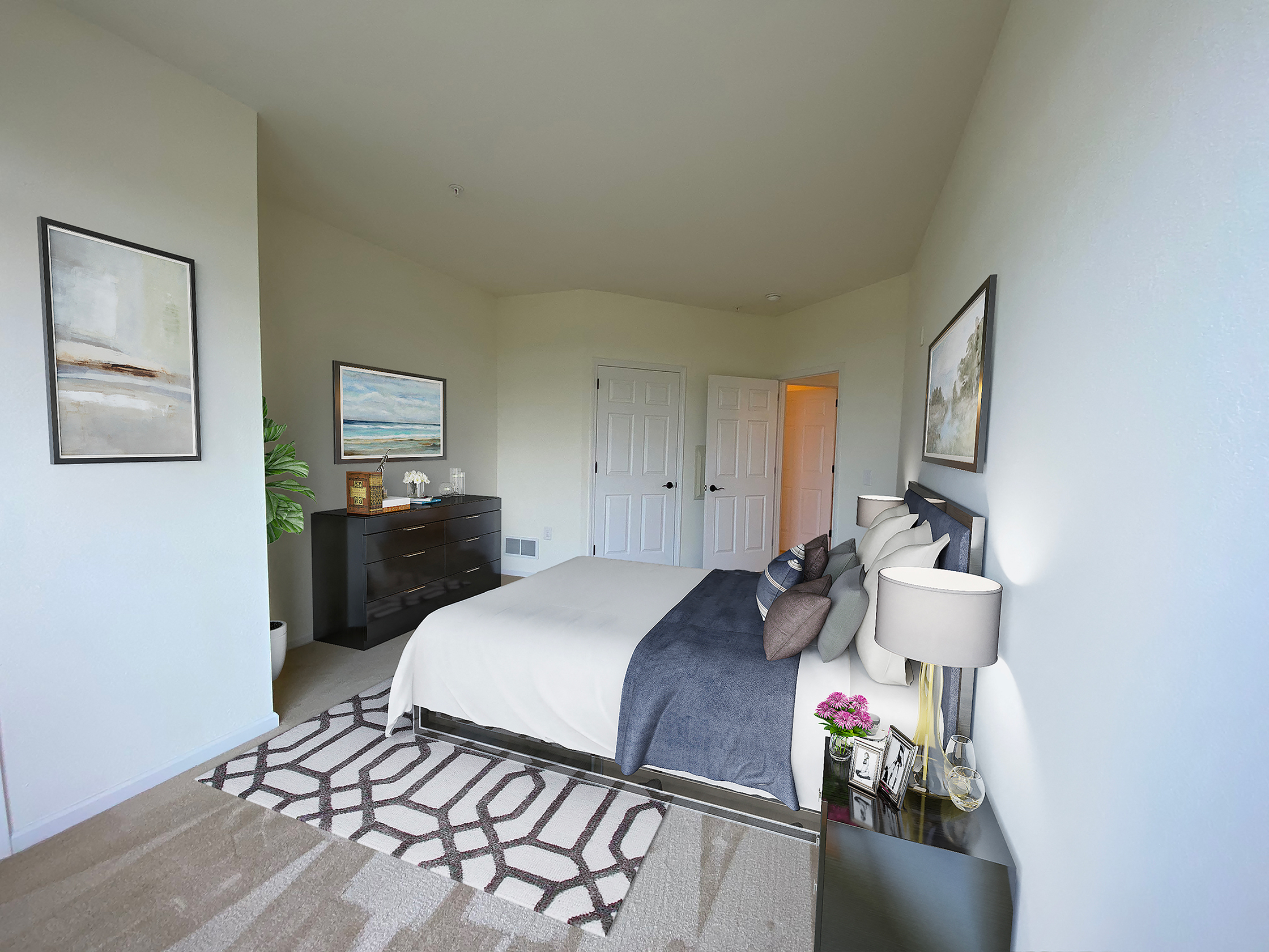 a bedroom with a bed and a dresser and a closet