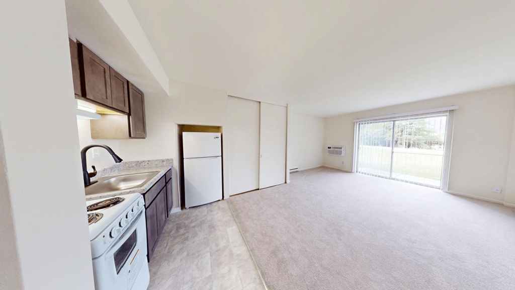 an empty kitchen with a stove and a refrigerator