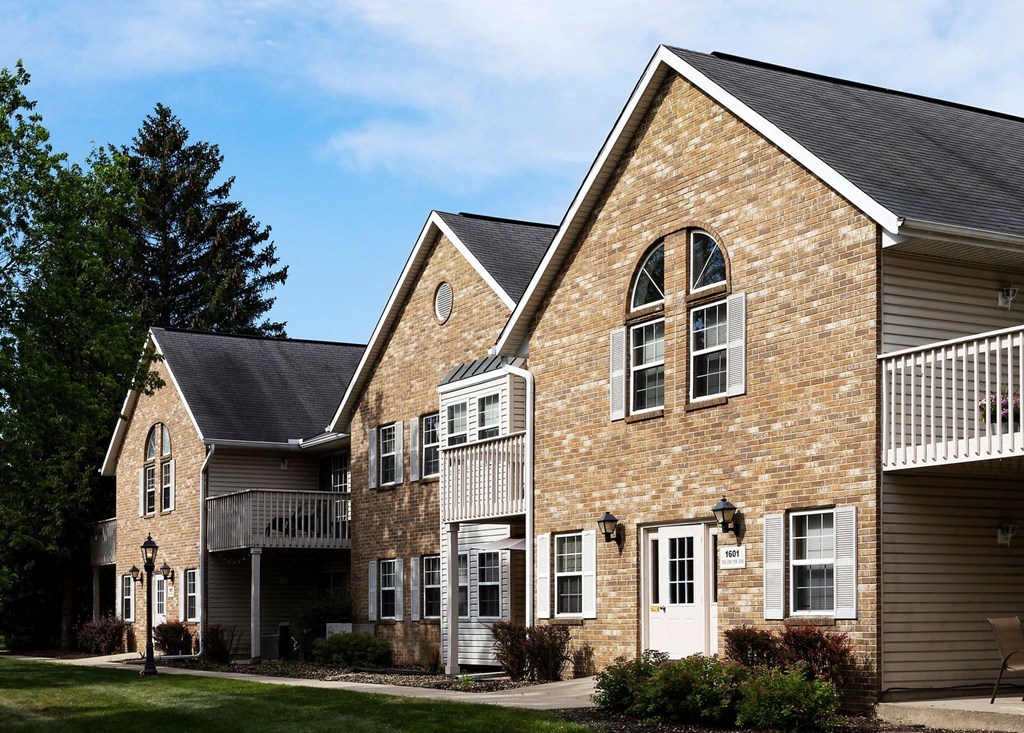 the front of a brick building with white doors and windows