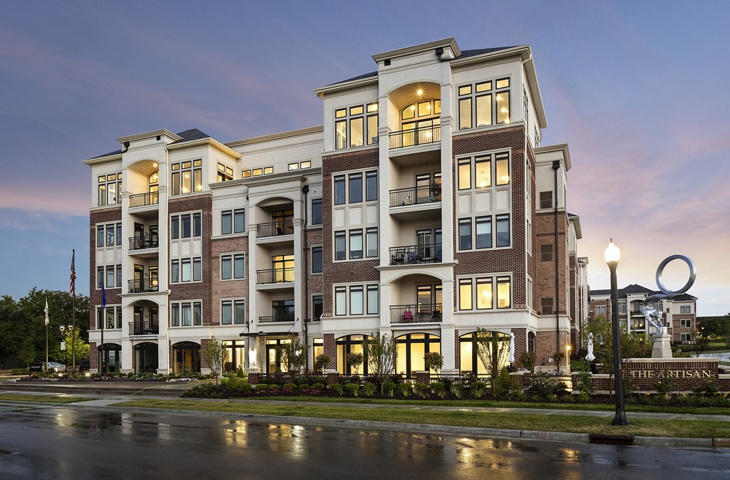an exterior view of an apartment building at dusk