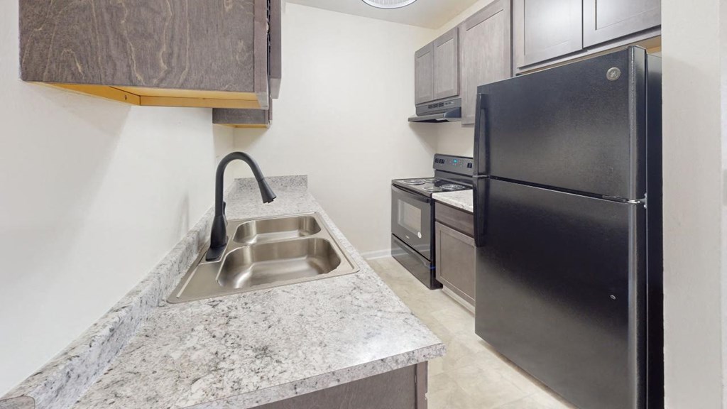 a kitchen with a sink and a refrigerator