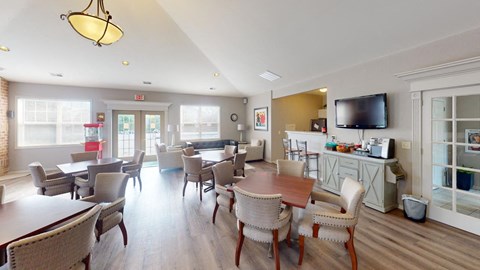 a dining room with tables and chairs and a television