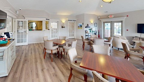 A large room with a long table and chairs.