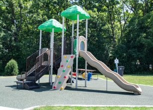 a childrens playground with slides and umbrellas