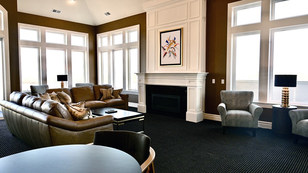 a living room with couches and chairs and a fireplace