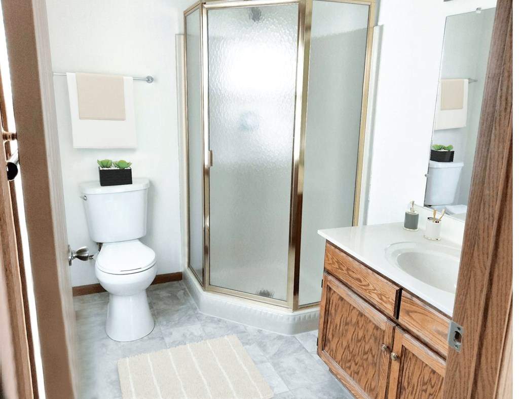 a small bathroom with a shower toilet and sink