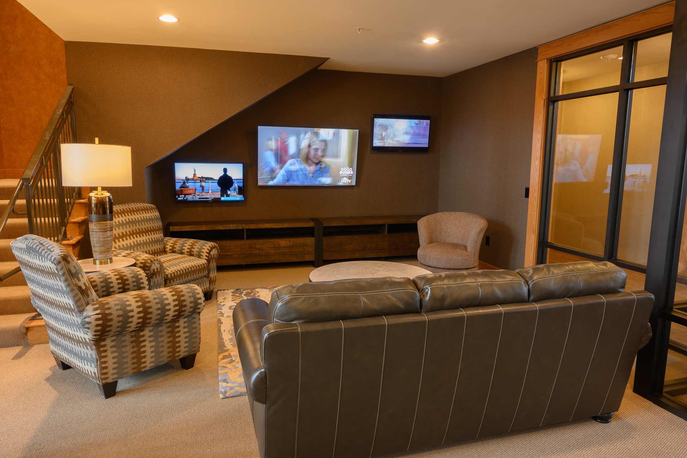 a living room with couches and chairs and a tv