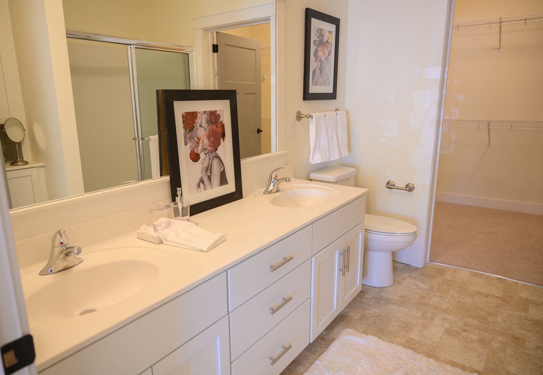 a bathroom with two sinks and a toilet and a mirror