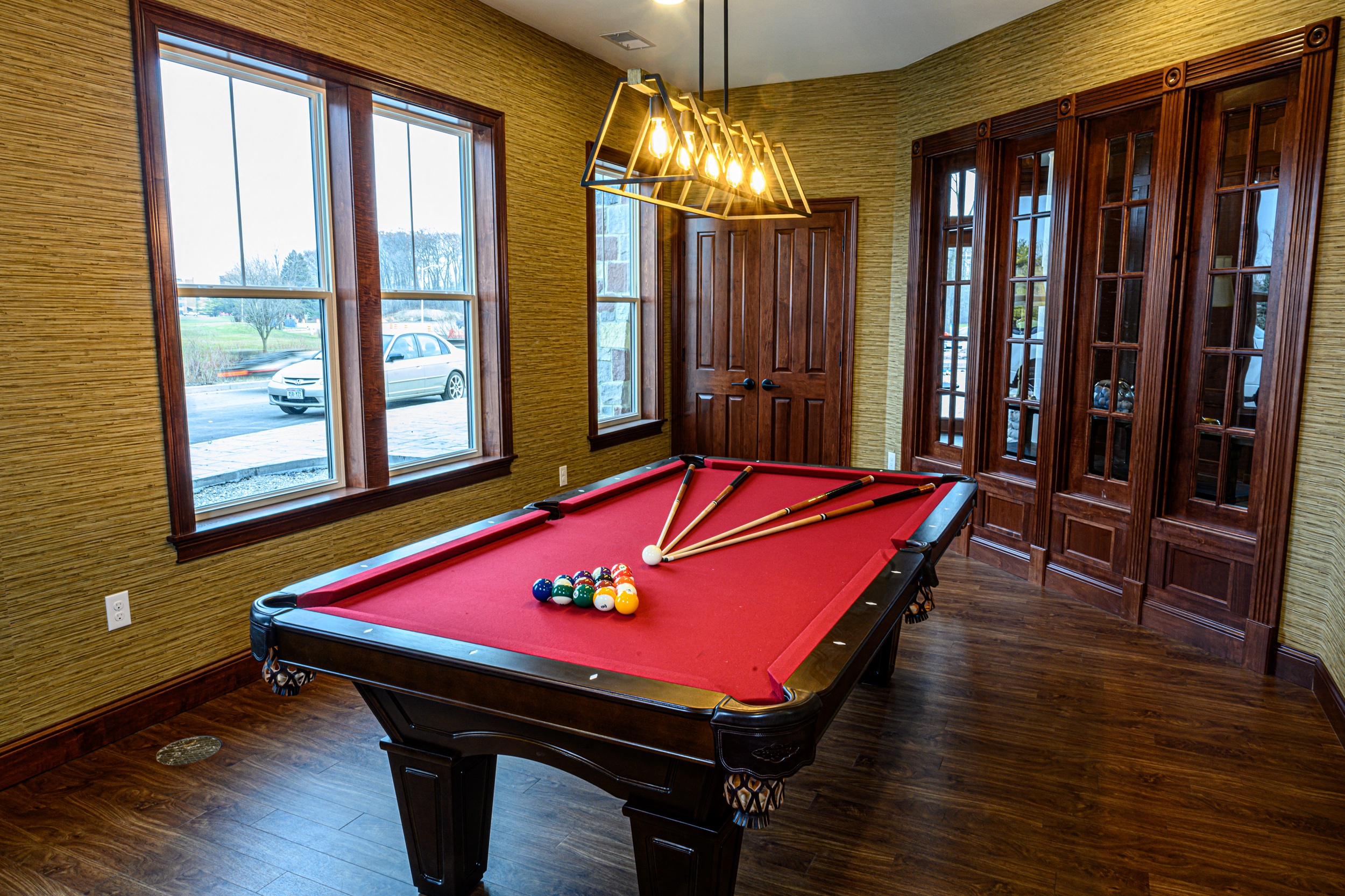 a red pool table in a billiard room