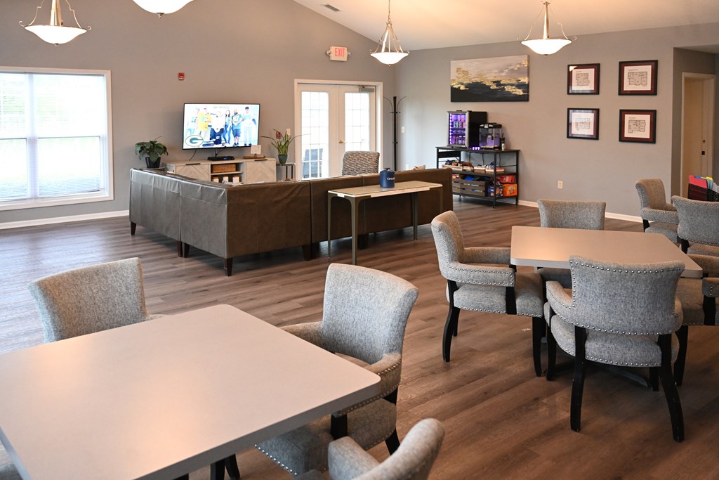 A conference room with a long table surrounded by chairs.
