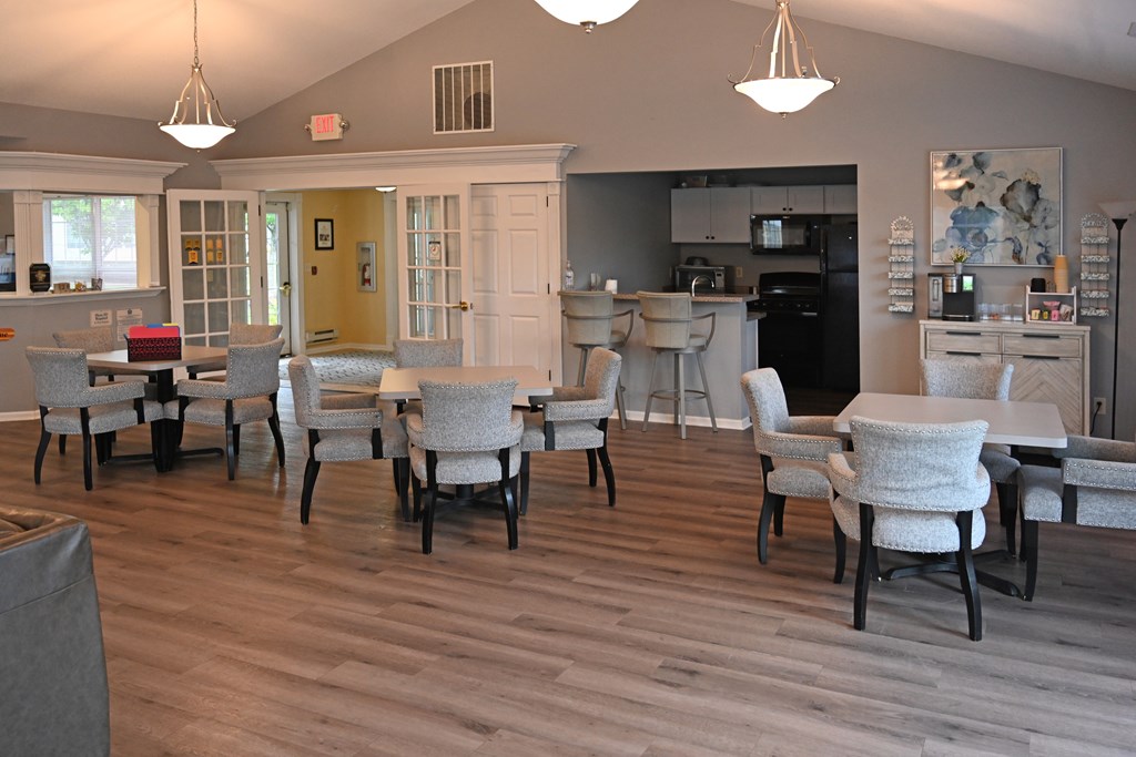 A dining room with a table and chairs.