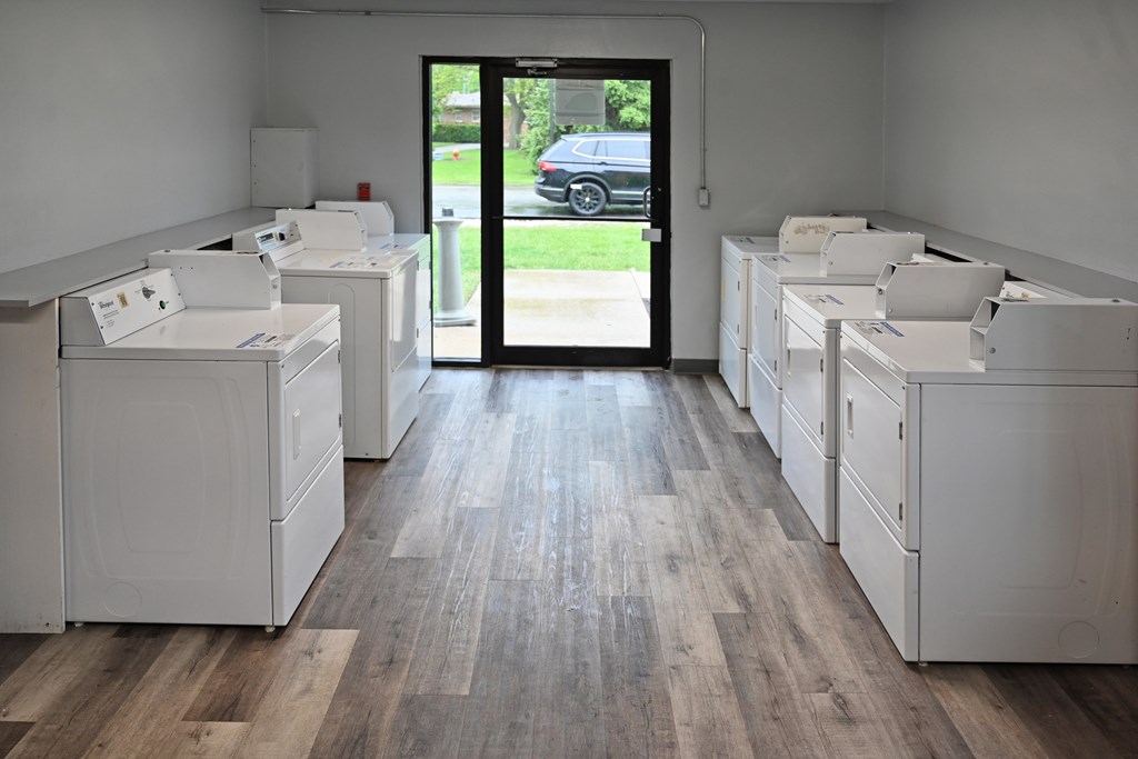 A row of white appliances are lined up in a room.