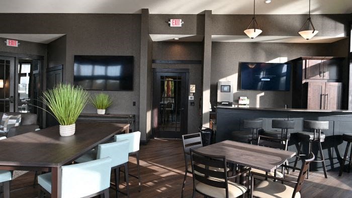 a dining room with a table and chairs and a kitchen