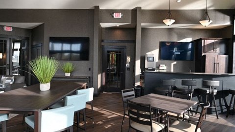 a dining room with a table and chairs and a kitchen