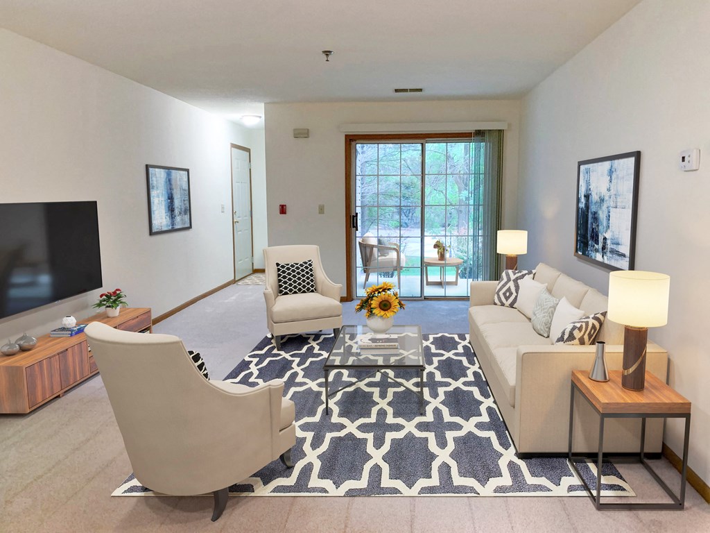 a living room with a couch and two chairs and a television