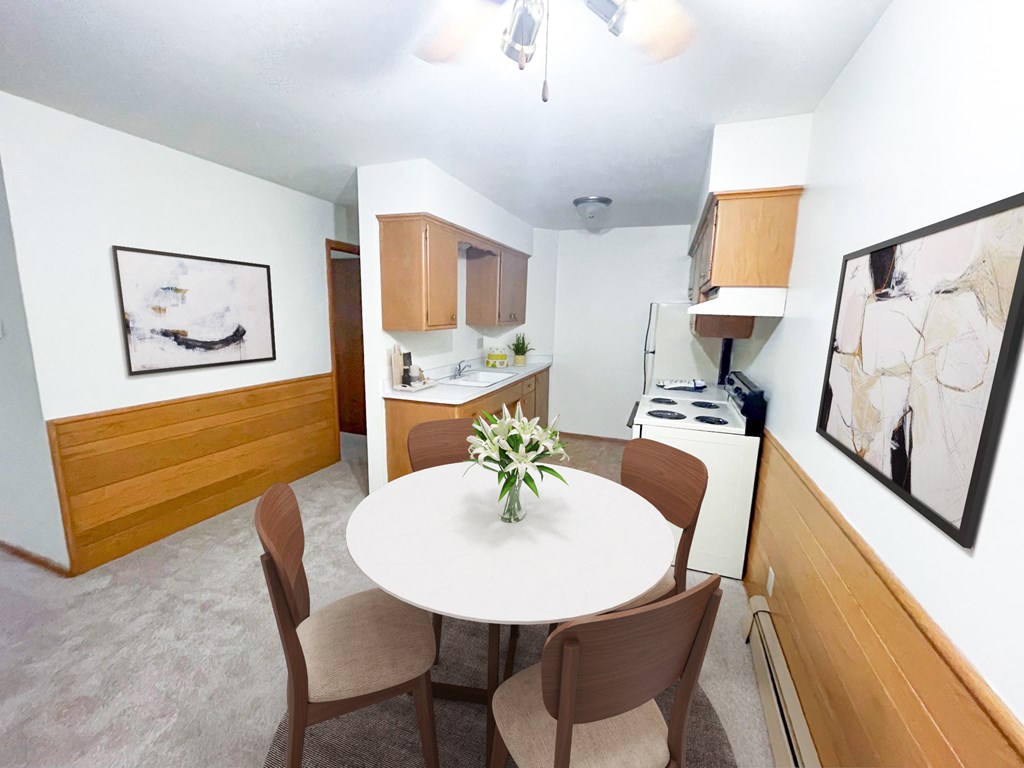 a dining room and kitchen with a table and chairs