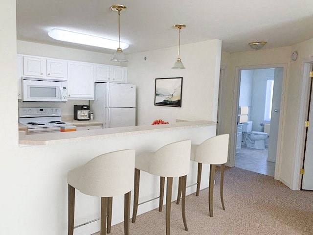 a kitchen with white cabinets and a counter top
