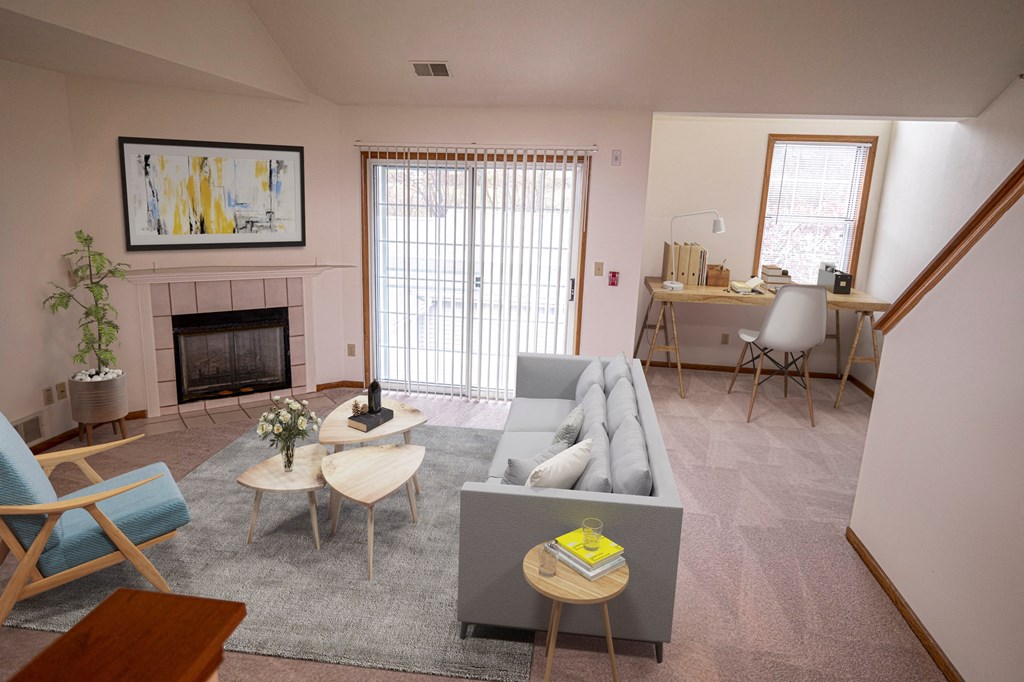 A living room with a grey couch, a blue chair, a coffee table, and a painting on the wall.