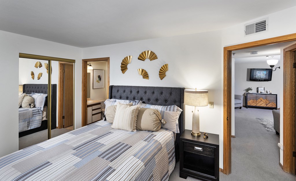 a bedroom with a bed and a mirror