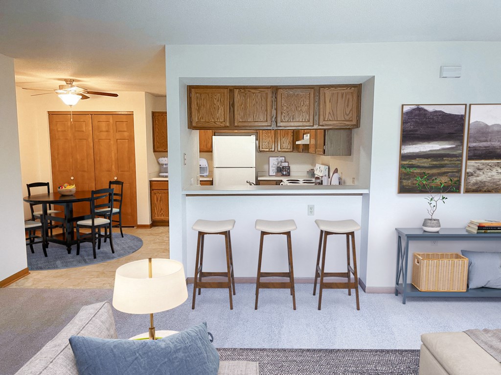 a living room with a kitchen and a bar with three stools