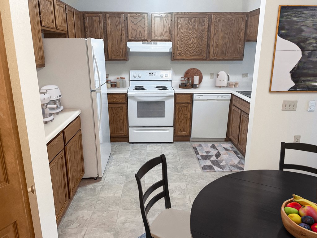 a kitchen with white appliances and wooden cabinets and a black table