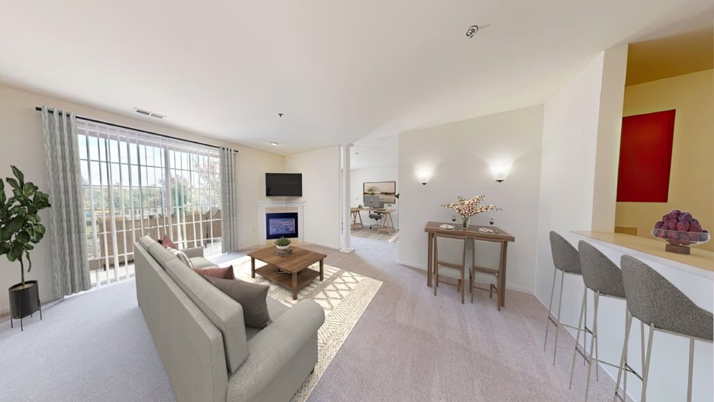 A living room with a grey couch, a wooden coffee table, and a flat screen TV.