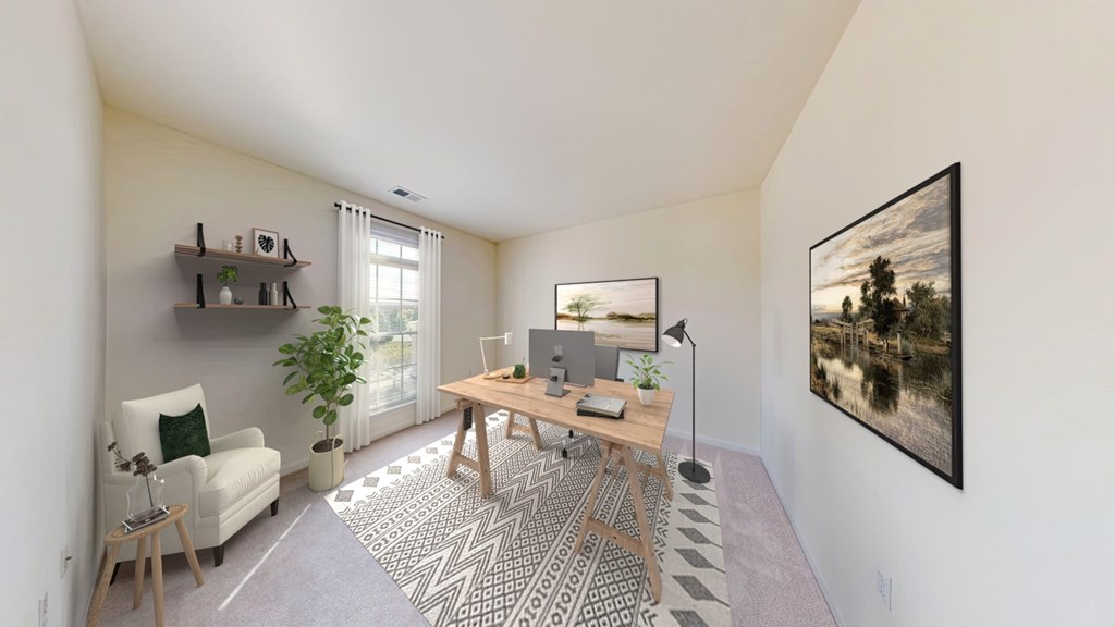 A room with a desk, chair, and a painting on the wall.